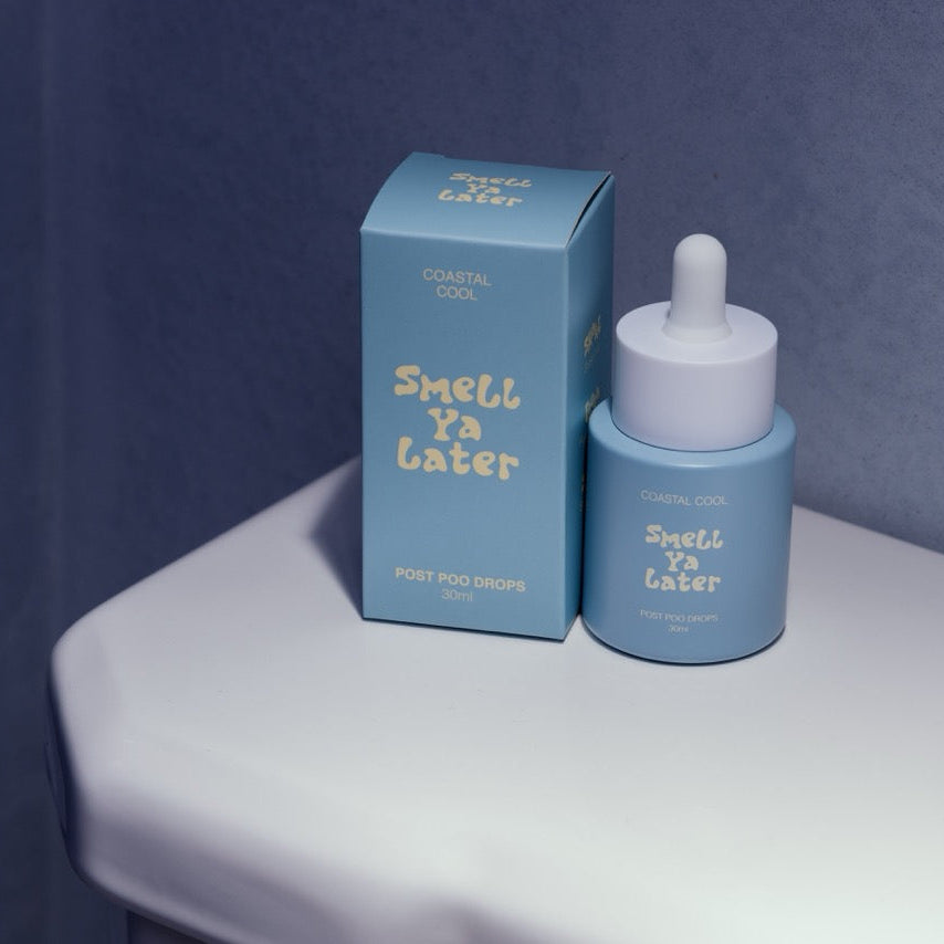 Blue bottle and box labeled 'Smell Ya Later' on a white surface with a blue background